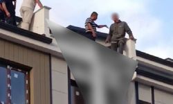 Eşiyle tartışıp çatıya çıkan genci, Belediye Başkanı çekip aldı